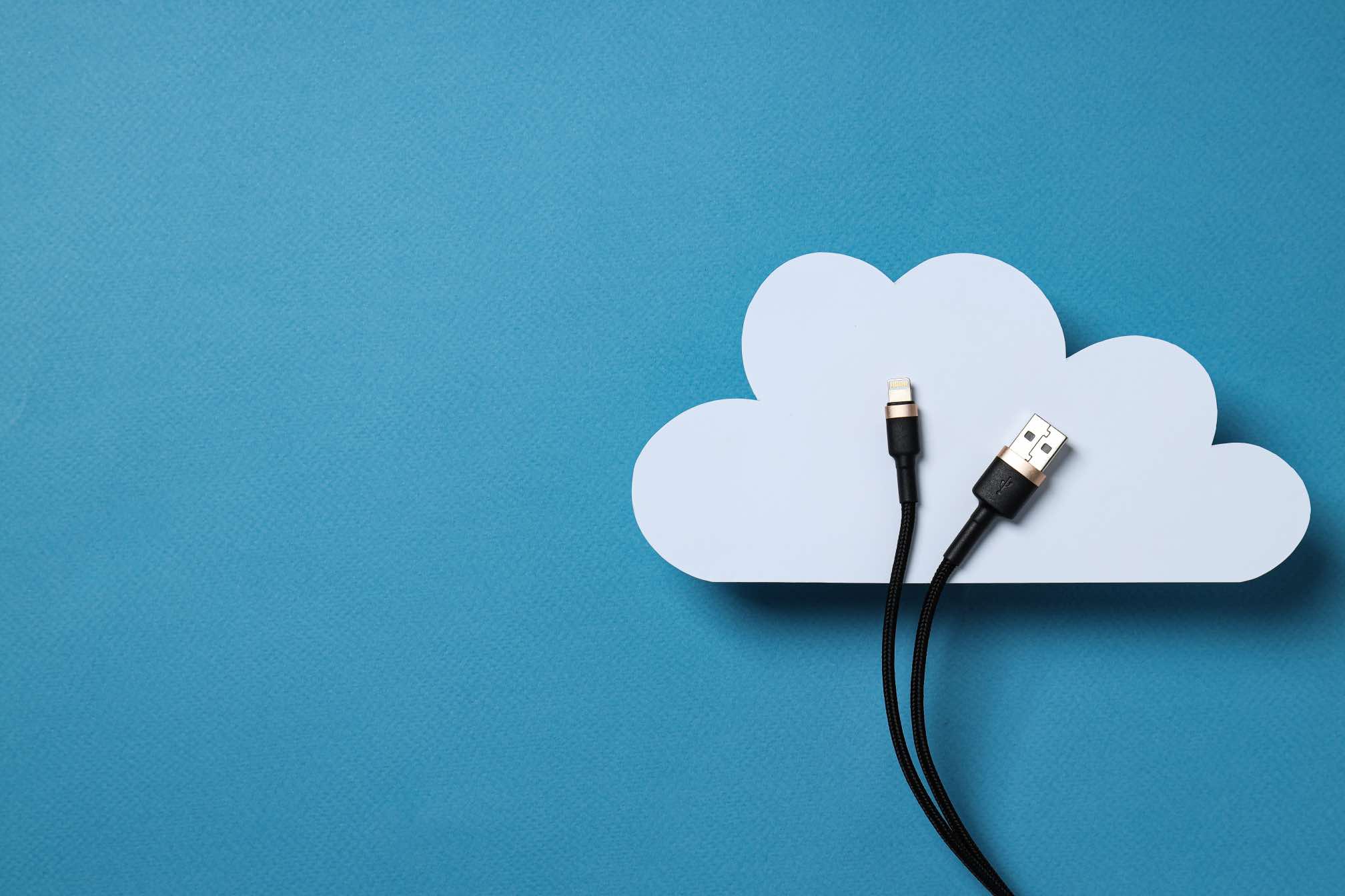 white-paper-cloud-with-a-black-usb-cable-on-a-blu-2025-03-25-07-00-04-utc
